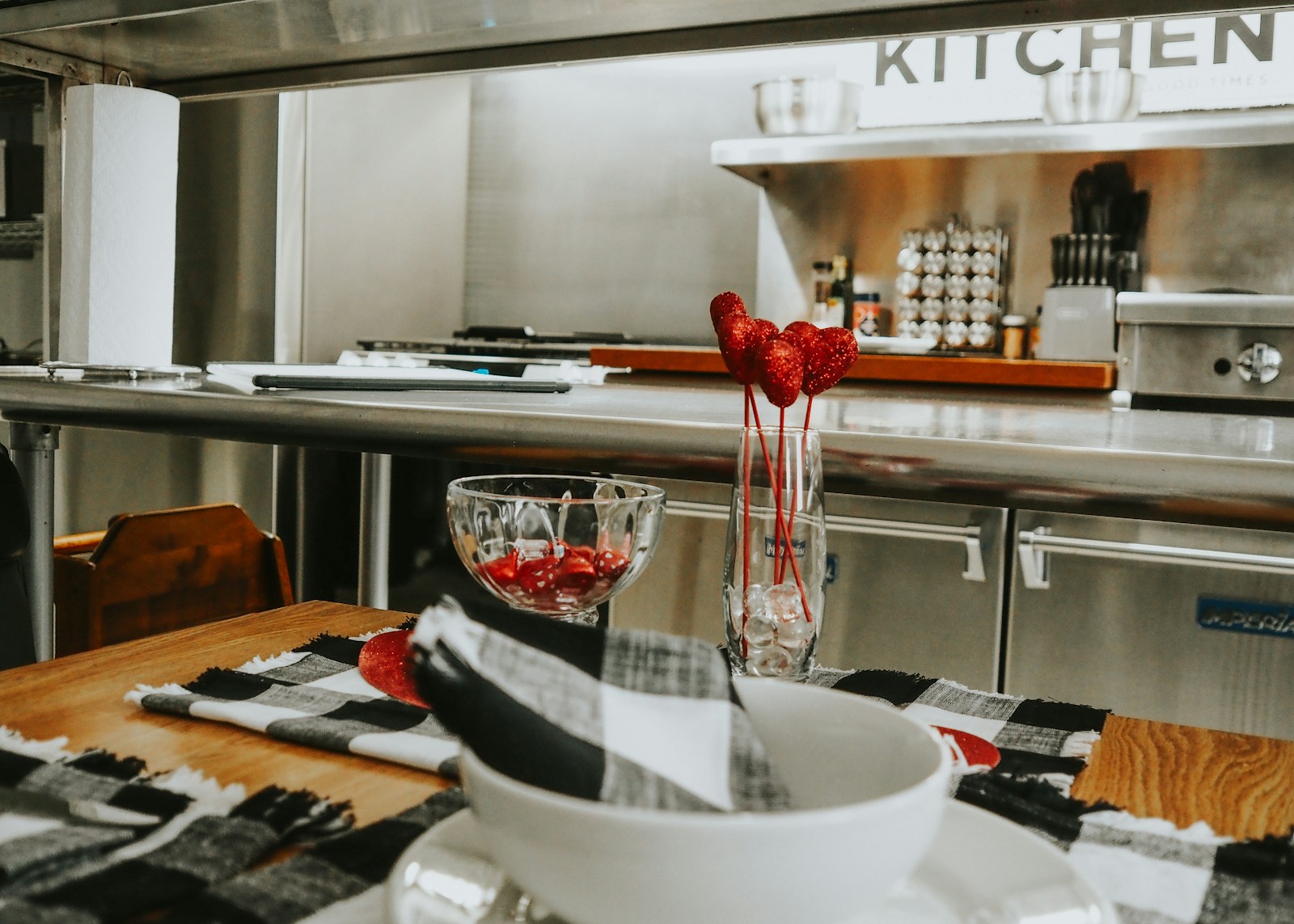 a kitchen with a bowl of strawberries on a table